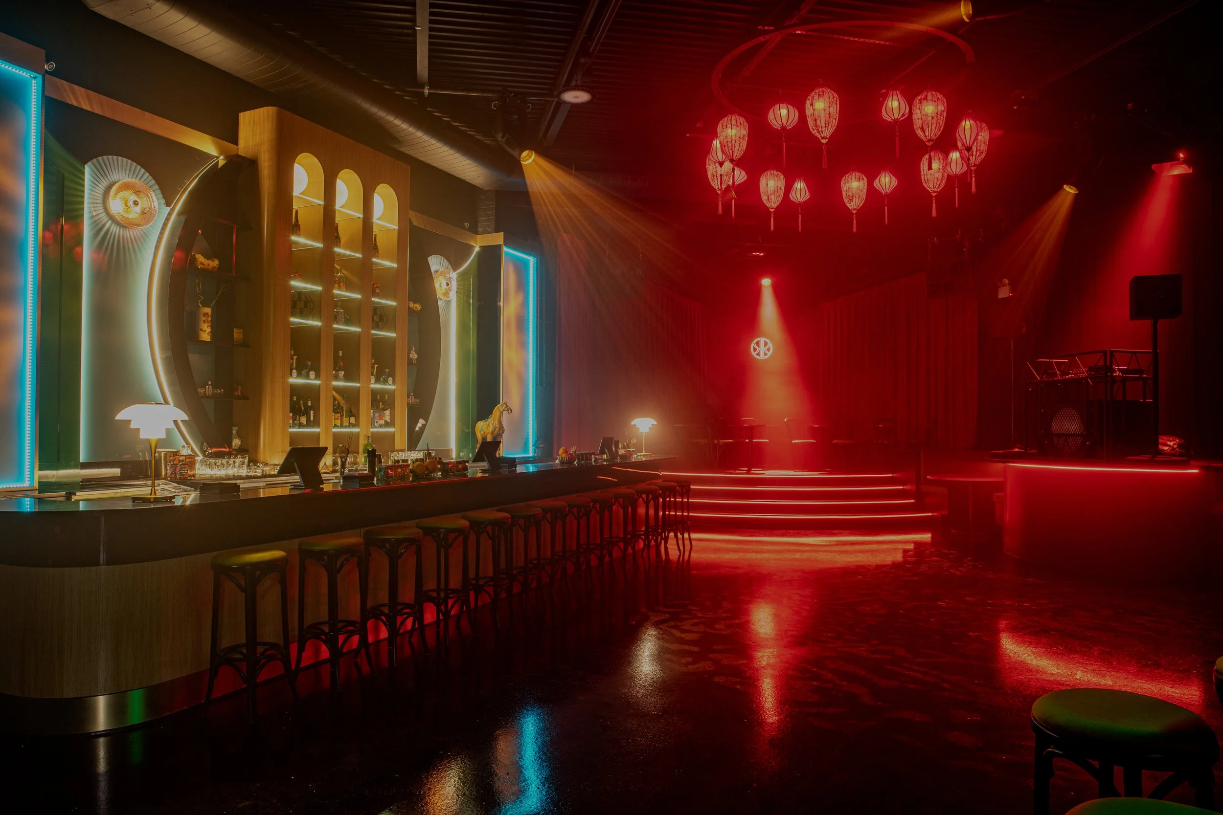 The candle-lit bar and red-lit lantern stage inside The Red Pavilion